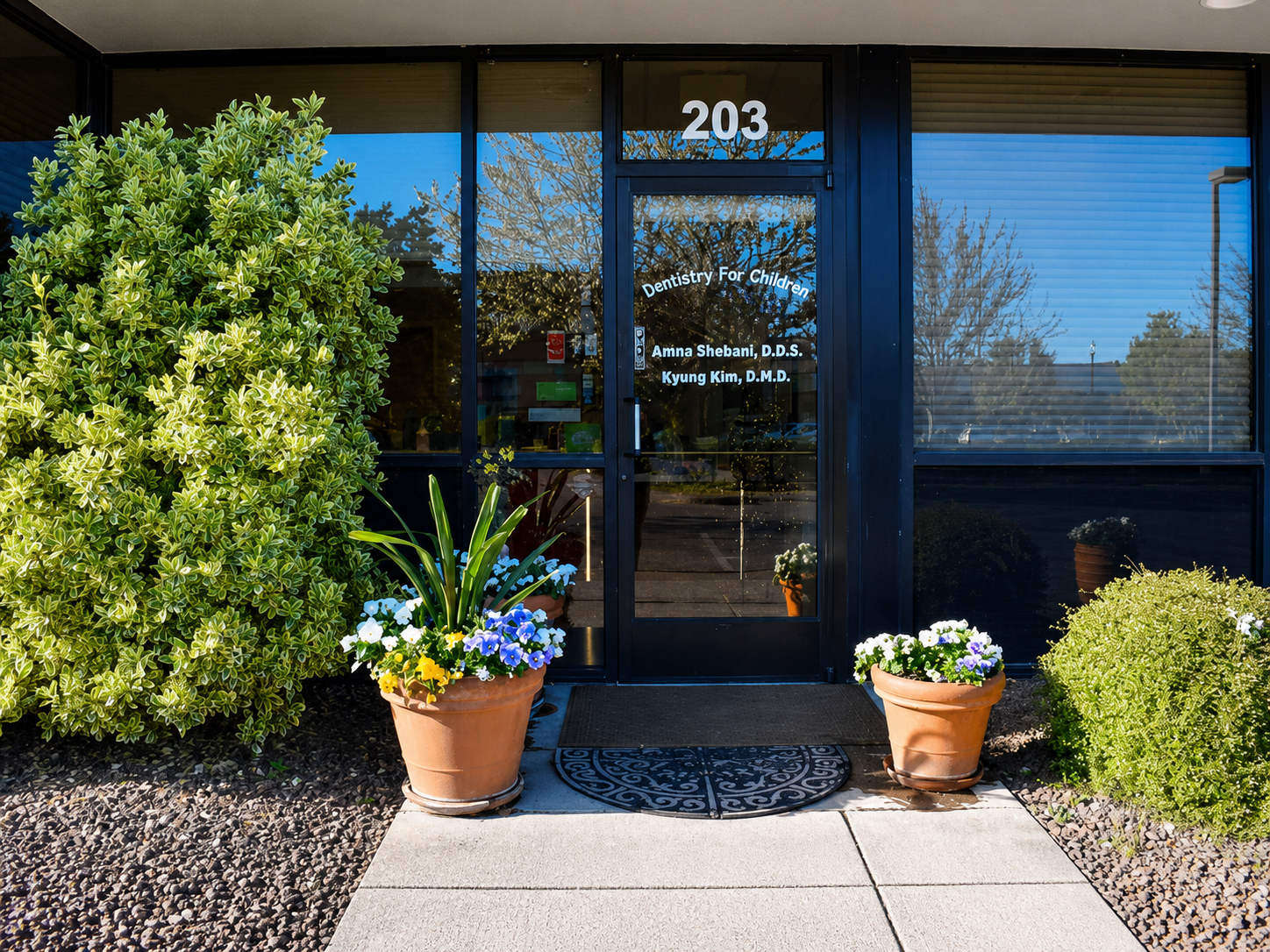 Front entrance of Dentistry for Children with flowers and office door
