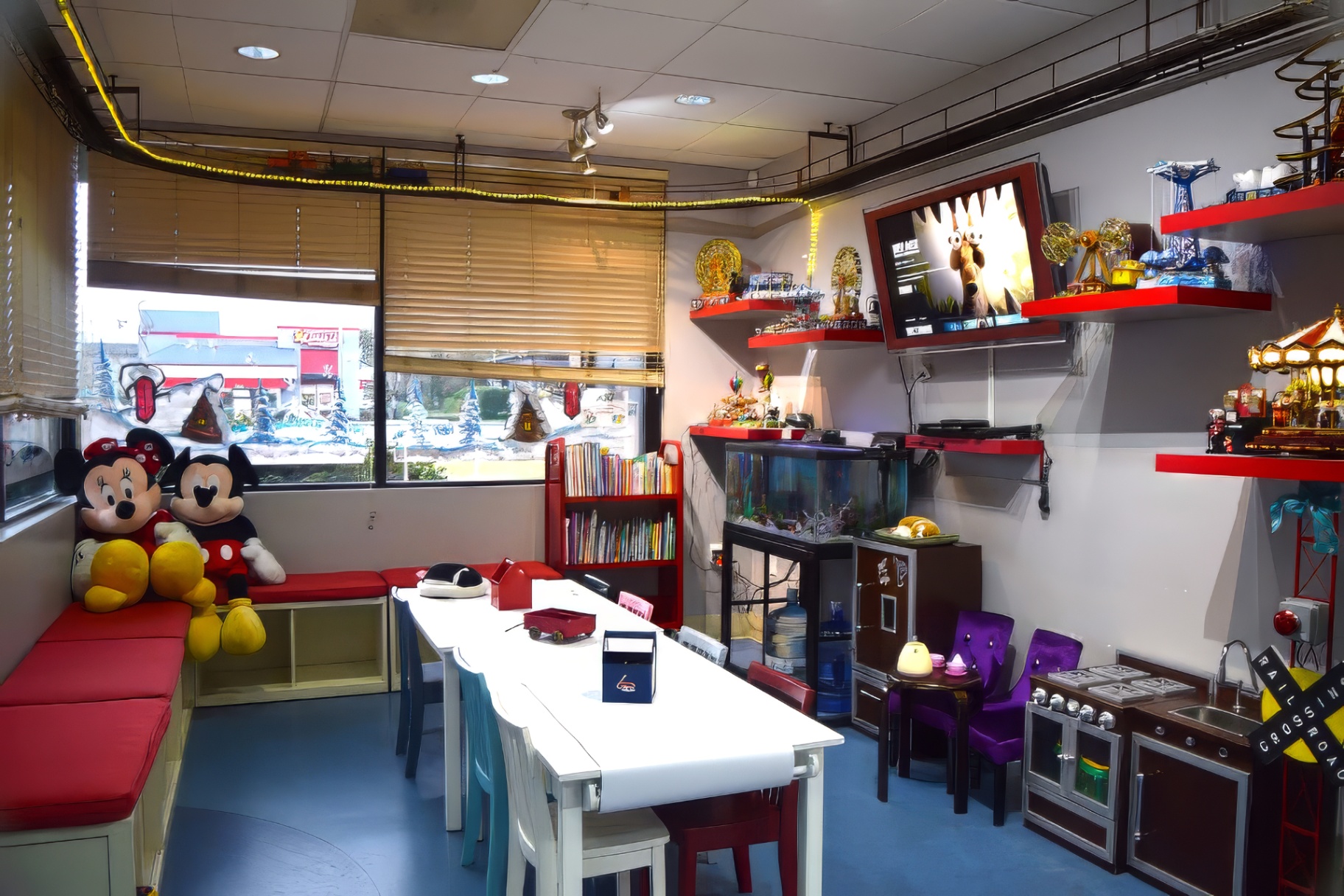 Indoor playroom with books, plush toys, play kitchen, and aquarium